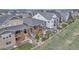Aerial view of a home, featuring a large deck, landscaped yard, and exterior stone accents at 9055 Swan River St, Littleton, CO 80125