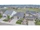 Aerial view of a gray single-Gathering home in a well-maintained community with open spaces and mountain views at 9055 Swan River St, Littleton, CO 80125