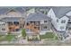 Aerial view of a home with wooden deck, manicured landscaping, and a stone exterior at 9055 Swan River St, Littleton, CO 80125