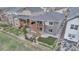 Aerial view of a home with a wooden deck, stone exterior and a charming landscaped yard at 9055 Swan River St, Littleton, CO 80125