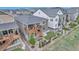 Aerial view of a home featuring a spacious wooden deck, landscaping, and rock accents in the yard at 9055 Swan River St, Littleton, CO 80125
