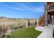 This home features a manicured backyard, artificial turf and neighborhood views at 9055 Swan River St, Littleton, CO 80125