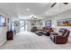 Basement living area featuring comfortable leather seating, an entertainment center, and bright lighting at 9055 Swan River St, Littleton, CO 80125