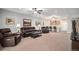 Finished basement features a full bar with granite counters, leather furniture, and neutral carpeting at 9055 Swan River St, Littleton, CO 80125