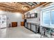 Unfinished basement with built-in storage and work area, perfect for a workshop or home improvement projects at 9055 Swan River St, Littleton, CO 80125