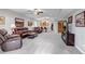 Spacious basement area with leather seating and a wet bar, perfect for entertaining and relaxation at 9055 Swan River St, Littleton, CO 80125