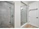 Contemporary bathroom features a tile shower with glass surround, and a white door at 9055 Swan River St, Littleton, CO 80125