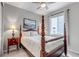 Bedroom features four-poster bed, neutral decor, side table and picture window at 9055 Swan River St, Littleton, CO 80125