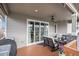 Covered patio with comfortable outdoor seating, ceiling fan, and view of the neighborhood beyond at 9055 Swan River St, Littleton, CO 80125
