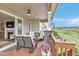 Spacious covered deck featuring comfortable seating, an outdoor fireplace, and stunning views at 9055 Swan River St, Littleton, CO 80125