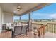 Cozy covered deck with comfortable seating, ceiling fan, and scenic neighborhood views at 9055 Swan River St, Littleton, CO 80125