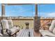Relaxing covered deck featuring comfortable seating and scenic neighborhood views at 9055 Swan River St, Littleton, CO 80125
