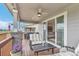 Inviting covered deck with outdoor seating, ceiling fan, and access to the living room at 9055 Swan River St, Littleton, CO 80125