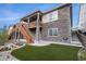 Attractive two-story home with stone accents, wood staircase, manicured landscaping and outdoor space at 9055 Swan River St, Littleton, CO 80125