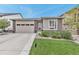 Single Gathering home boasting stone accents, an attached two-car garage, and a meticulously maintained front yard at 9055 Swan River St, Littleton, CO 80125
