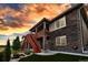 Stunning exterior view of a home with stone accents, outdoor porch and professional landscaping at 9055 Swan River St, Littleton, CO 80125
