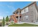 Charming home features a lovely stone exterior and a spacious wooden deck with stairs at 9055 Swan River St, Littleton, CO 80125