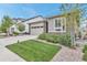 Beautiful single Gathering home featuring stone accents and a well-maintained front yard with lush greenery and trees at 9055 Swan River St, Littleton, CO 80125