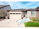Charming single-story home featuring a two-car garage, stone accents, and a well-manicured lawn at 9055 Swan River St, Littleton, CO 80125