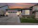 Charming single Gathering home with a gray exterior, stone accents, and a two-car garage at sunset at 9055 Swan River St, Littleton, CO 80125
