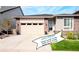 Charming single-Gathering home with a two-car garage, stone accents, and well-maintained landscaping on a sunny day at 9055 Swan River St, Littleton, CO 80125