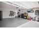 Well-organized garage with epoxy floors, storage shelves, and ample space for vehicles and equipment at 9055 Swan River St, Littleton, CO 80125