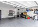 Spacious garage features epoxy floors, ample storage, and workbench area at 9055 Swan River St, Littleton, CO 80125