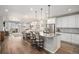 Open concept kitchen with island seating, a stainless steel refrigerator, and plenty of cabinet space at 9055 Swan River St, Littleton, CO 80125