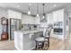 Beautiful, bright kitchen with granite countertops, stainless appliances, a breakfast bar and a stone backsplash at 9055 Swan River St, Littleton, CO 80125