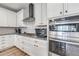 Well-lit kitchen features white cabinets, stainless steel appliances, granite countertops, and a decorative backsplash at 9055 Swan River St, Littleton, CO 80125