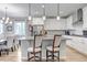 Well-designed kitchen with stainless appliances, pendant lighting over a granite-topped island and breakfast bar seating at 9055 Swan River St, Littleton, CO 80125