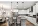 Bright eat-in kitchen features granite counters, hardwood flooring, stainless appliances, and pendant lighting at 9055 Swan River St, Littleton, CO 80125