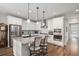 Gourmet kitchen featuring stainless steel appliances, an island with bar seating, and wood flooring at 9055 Swan River St, Littleton, CO 80125