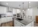 Beautiful kitchen boasts granite countertops, stainless appliances, white cabinetry, and barstool seating at 9055 Swan River St, Littleton, CO 80125