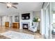 Bright living room with a fireplace, a large TV, and a cozy armchair at 9055 Swan River St, Littleton, CO 80125
