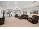 Spacious living room with comfortable leather furniture and a sliding glass door to the outside at 9055 Swan River St, Littleton, CO 80125
