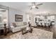 Bright living room with a seamless flow into the adjacent kitchen and dining area, with natural light at 9055 Swan River St, Littleton, CO 80125