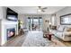 Inviting living room featuring a cozy fireplace, modern ceiling fan and sliding glass doors to outdoor living at 9055 Swan River St, Littleton, CO 80125