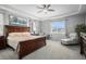 Spacious main bedroom features a large window, tray ceiling, and comfortable seating at 9055 Swan River St, Littleton, CO 80125