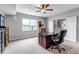 Bright office space featuring a wooden desk, comfortable chair, and large windows with scenic views at 9055 Swan River St, Littleton, CO 80125