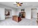 Comfortable office with wooden desk, ceiling fan, and bright light; ideal for working from home at 9055 Swan River St, Littleton, CO 80125