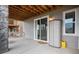 Lower level patio with exterior door, storage, and space for outdoor enjoyment and convenience at 9055 Swan River St, Littleton, CO 80125