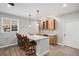 Wet bar with barstool seating, wood cabinets, updated countertops, and a window for natural light at 9055 Swan River St, Littleton, CO 80125