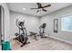 Home workout room with stationary bike, elliptical trainer, weights and mirrors at 9055 Swan River St, Littleton, CO 80125