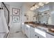 Elegant bathroom featuring double vanity sinks, modern fixtures, and a spacious shower at 1176 Sugarloaf Ln, Erie, CO 80516