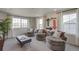Bright living room features ample natural light, comfortable seating, and a playful arrow design on the wall at 1176 Sugarloaf Ln, Erie, CO 80516