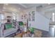 Bright living room with open layout and adjacent kitchen provides an airy feel for seamless living and entertaining at 1176 Sugarloaf Ln, Erie, CO 80516