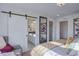 Main bedroom features a barn door leading to the ensuite bathroom at 1176 Sugarloaf Ln, Erie, CO 80516