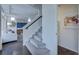 Carpeted staircase with hardwood floors and living area visible nearby creates an inviting and stylish transition at 1176 Sugarloaf Ln, Erie, CO 80516