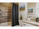 Clean bathroom with shower/tub, wood-look tile, and modern vanity at 6922 Copper Sky Cir, Castle Pines, CO 80108